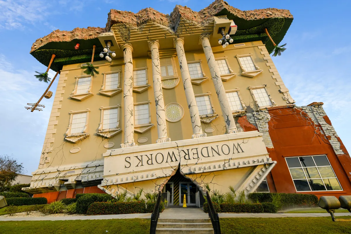 The whimsical, upside-down facade of WonderWorks, a popular family attraction nearby. The building’s unique architecture and bright colors create an inviting and adventurous atmosphere, perfect for sparking curiosity and excitement among kids and adults alike.
